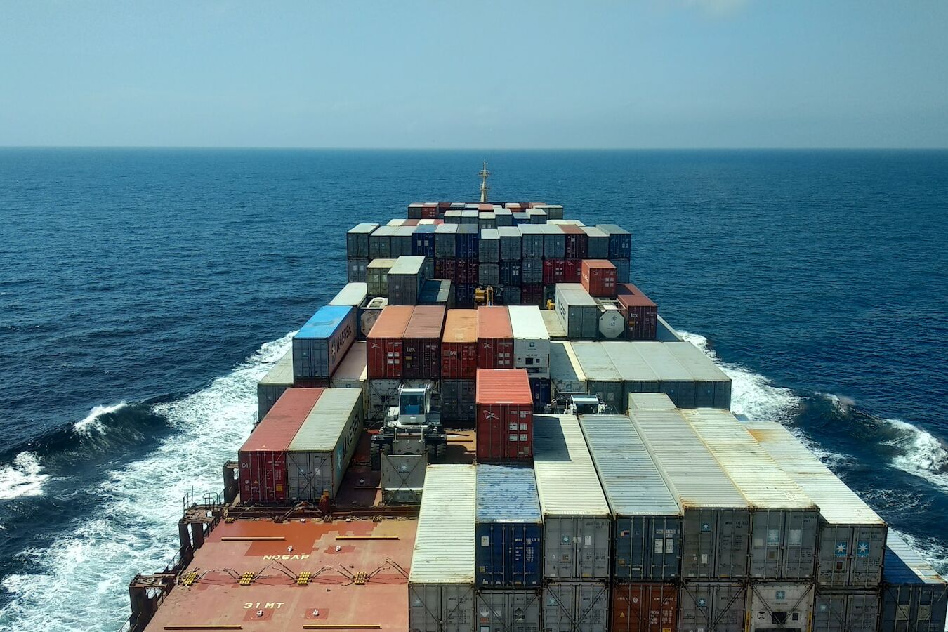 red and white cargo ship on sea during daytime