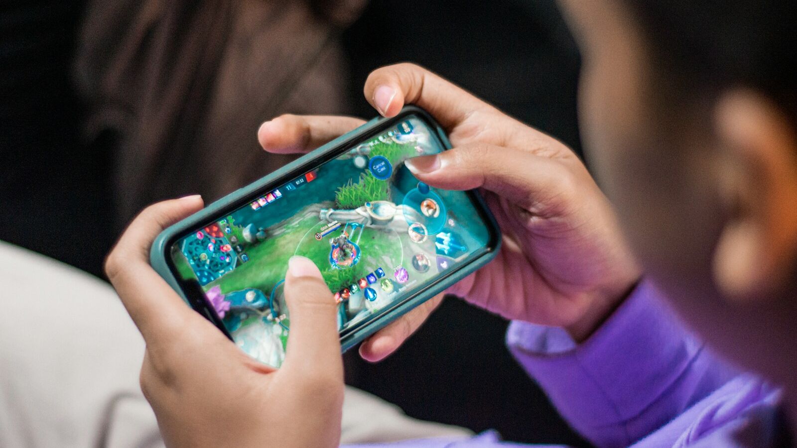 a person holding a cell phone in their hands