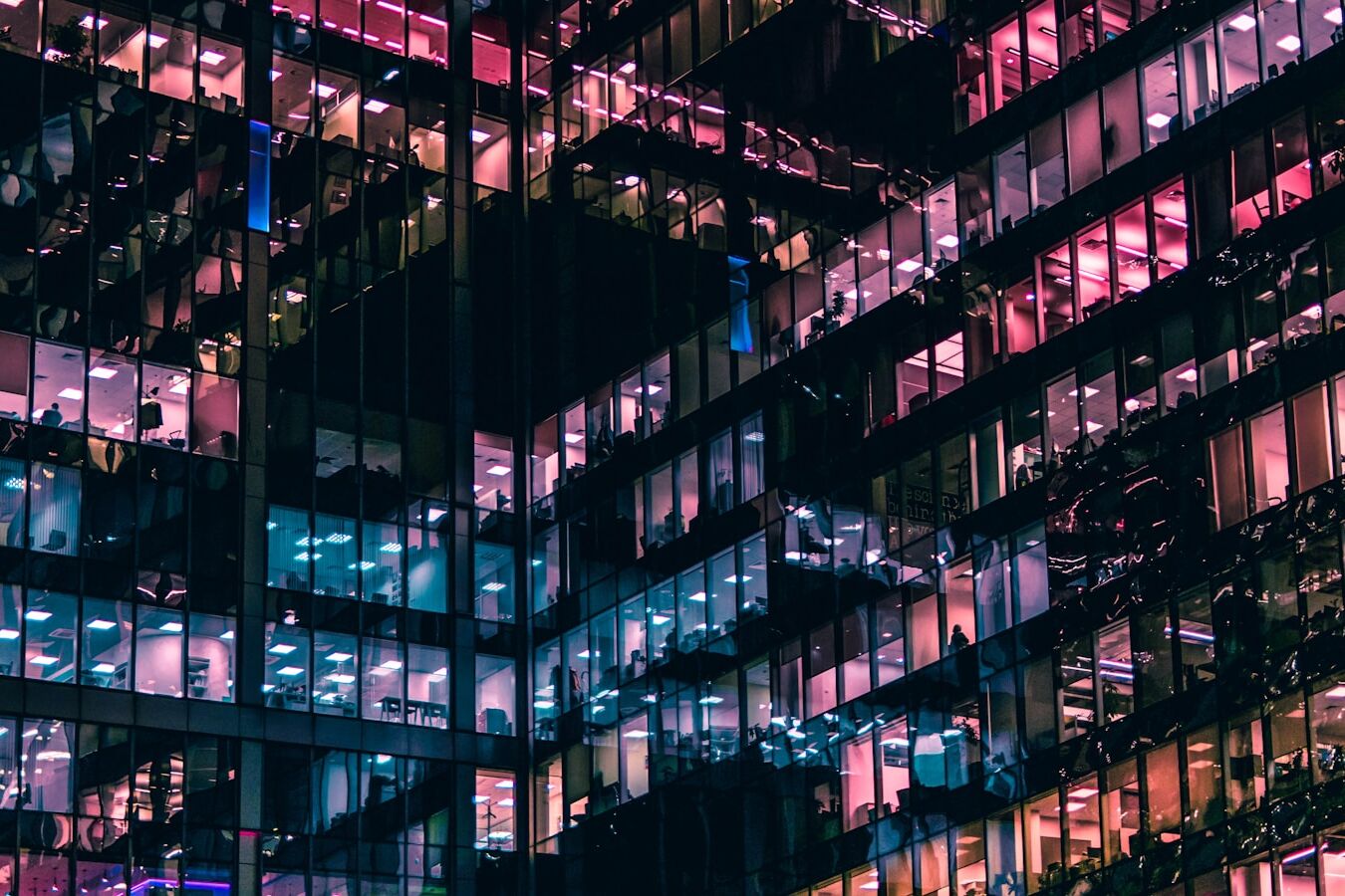 architectural photography of building with people in it during nighttime