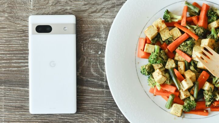a plate of food with a cell phone next to it