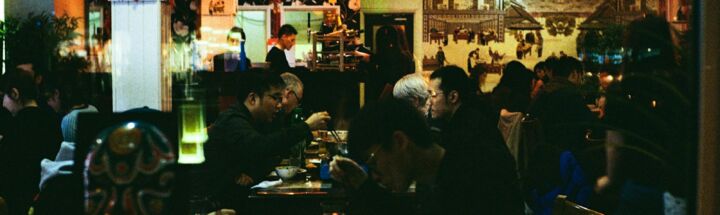 a group of people eating at a restaurant