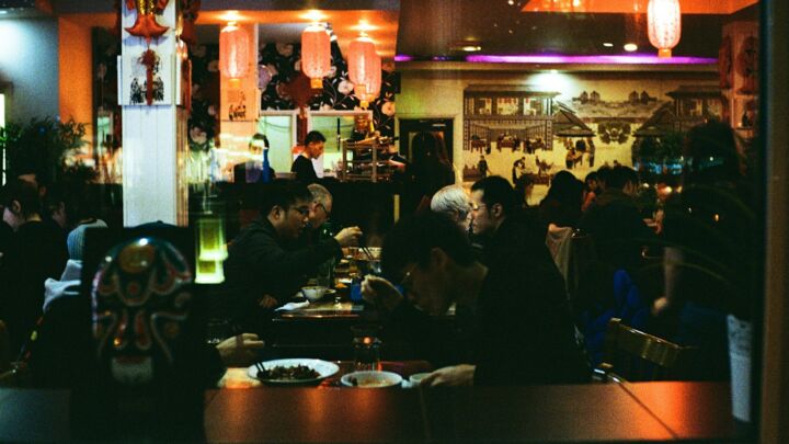 a group of people eating at a restaurant