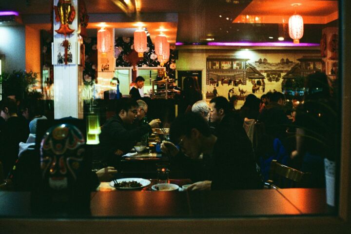 a group of people eating at a restaurant