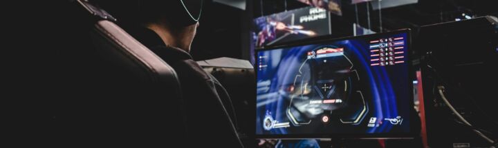 person sitting on gaming chair while playing video game