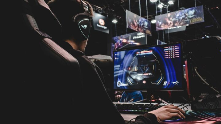 person sitting on gaming chair while playing video game