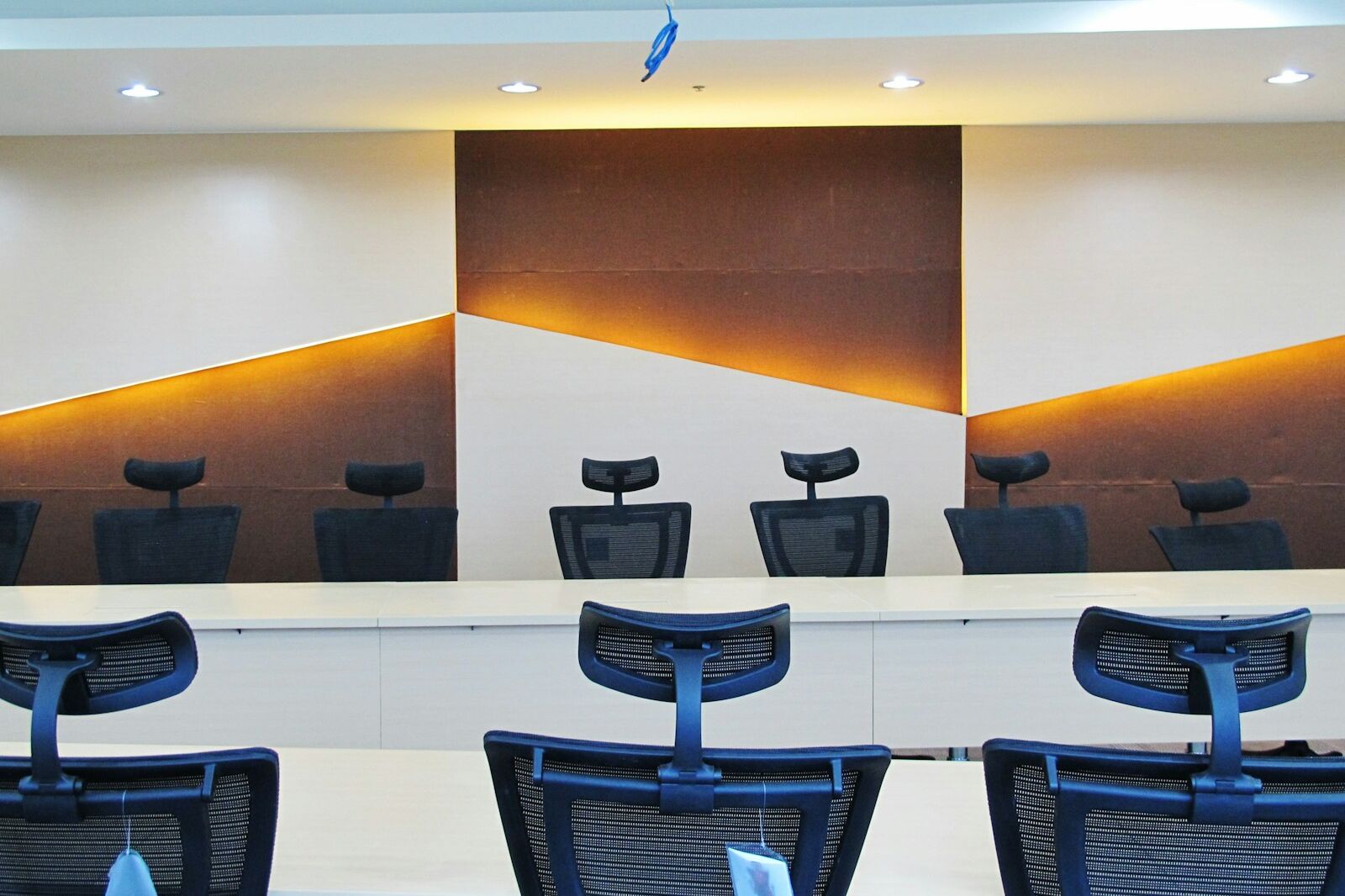 a conference room with chairs and a large painting on the wall