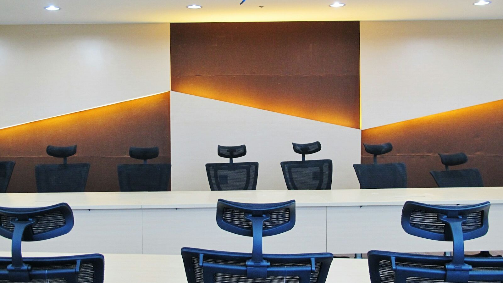 a conference room with chairs and a large painting on the wall