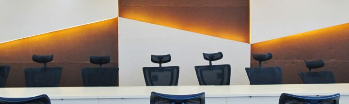a conference room with chairs and a large painting on the wall