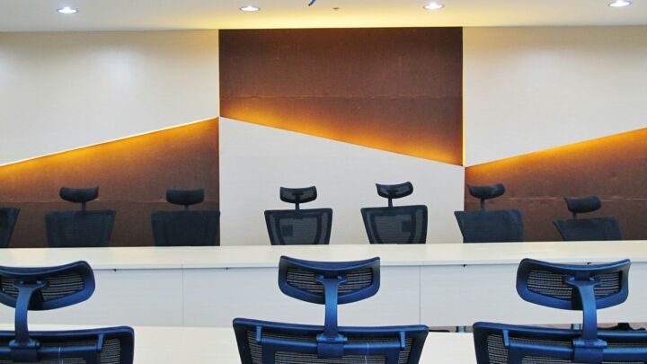 a conference room with chairs and a large painting on the wall