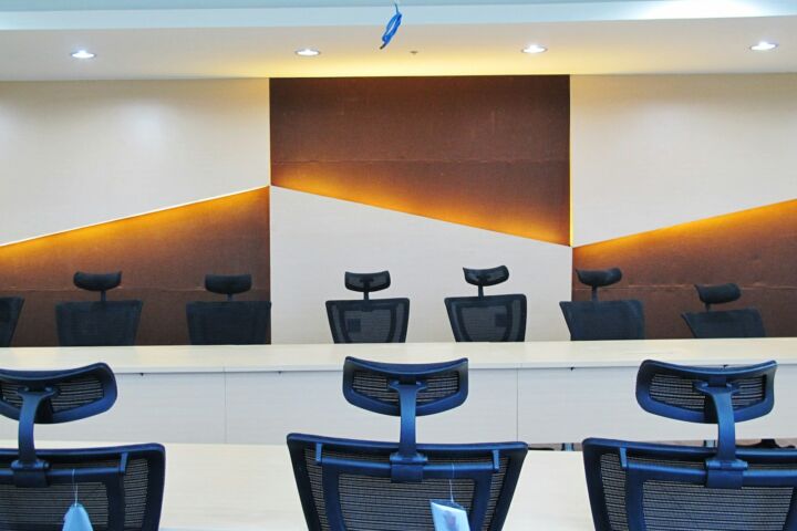 a conference room with chairs and a large painting on the wall