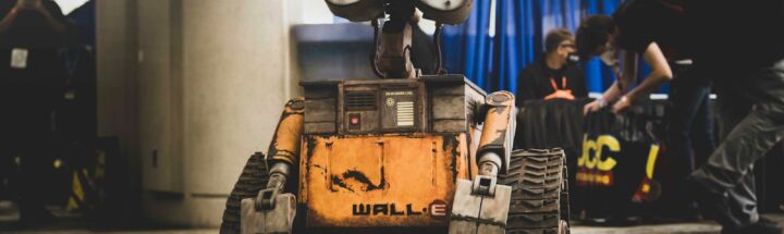 Wall-e robot is center in a convention hall.