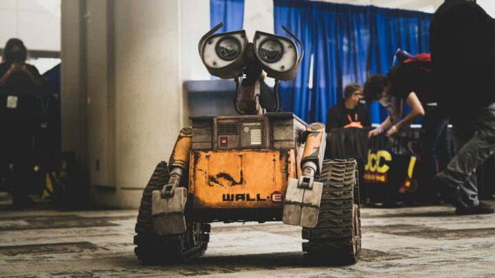 Wall-e robot is center in a convention hall.