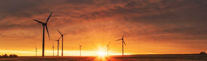 windmill on grass field during golden hour