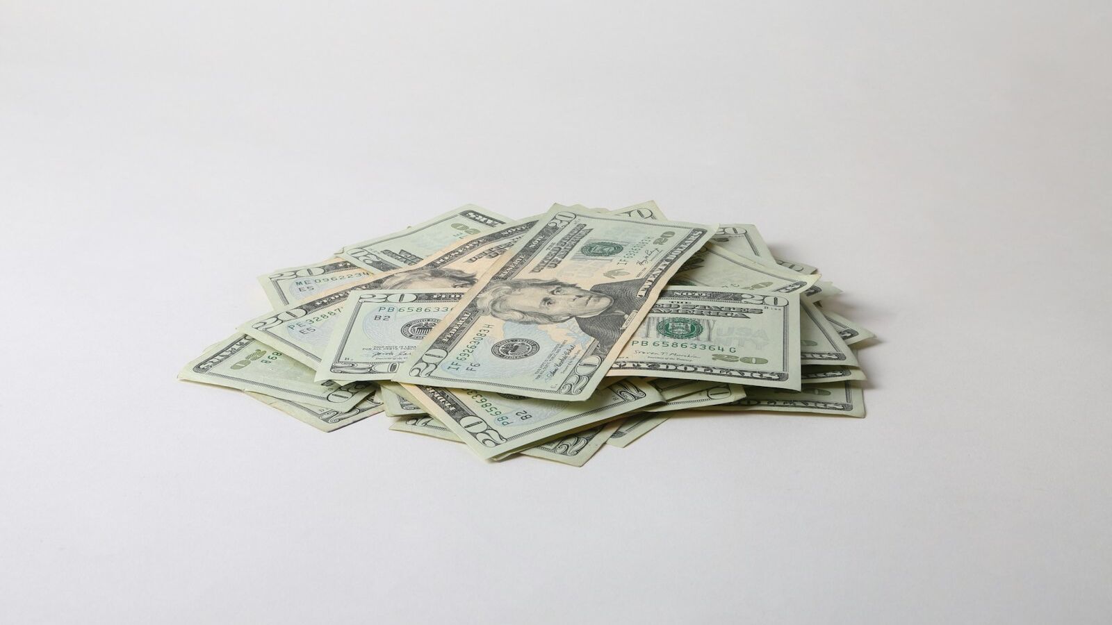 a pile of money sitting on top of a white table