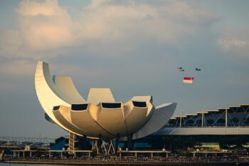 Modern building with curved white petals against sky
