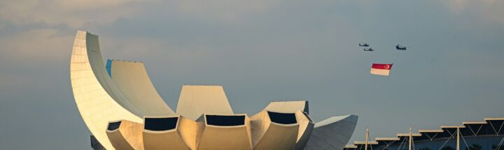 Modern building with curved white petals against sky