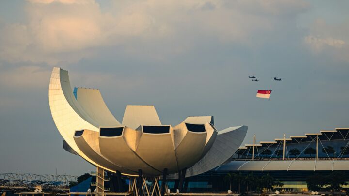 Modern building with curved white petals against sky