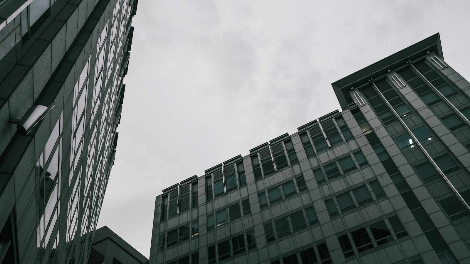 a couple of tall buildings sitting next to each other
