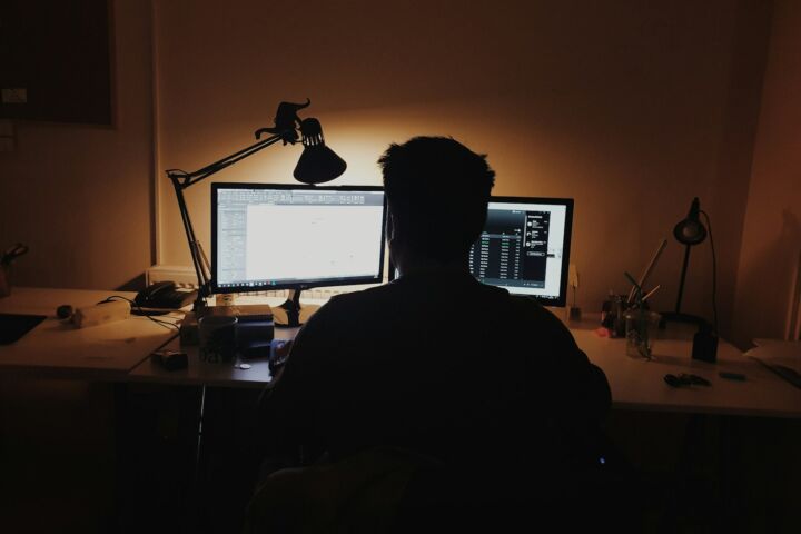 man using computer inside room