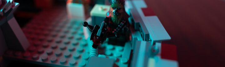 a close up of a lego model of a man with a gun