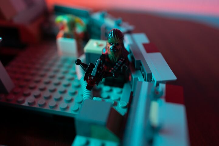 a close up of a lego model of a man with a gun