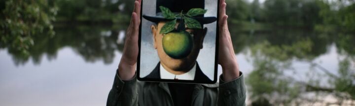 person holding black tablet computer with green fruit
