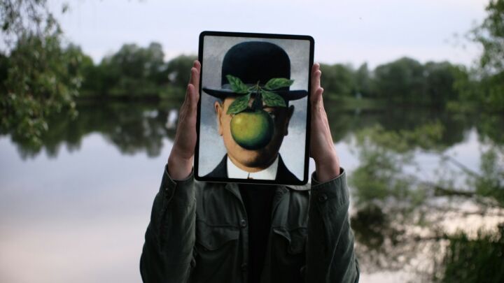 person holding black tablet computer with green fruit