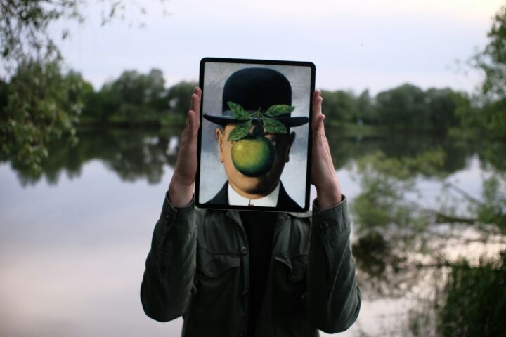 person holding black tablet computer with green fruit