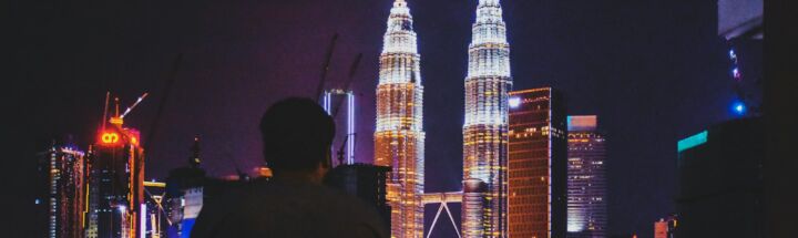 man standing near Petronas Tower