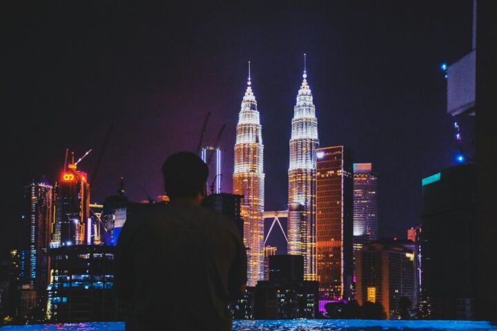 man standing near Petronas Tower