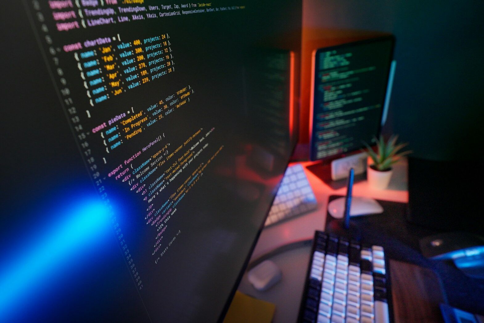 Coding code on multiple computer screens.