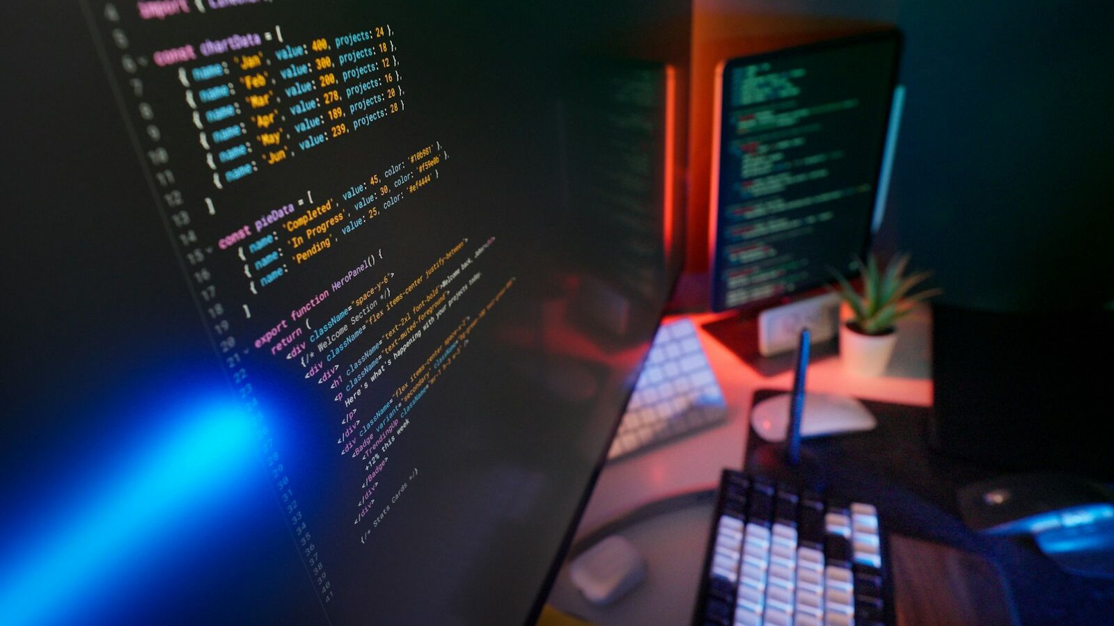 Coding code on multiple computer screens.