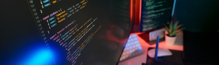 Coding code on multiple computer screens.