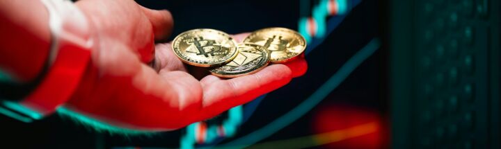 A person holding two gold coins in their hand