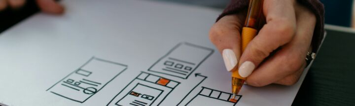 yellow click pen on white printer paper