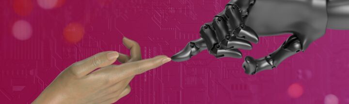 two hands touching each other in front of a pink background