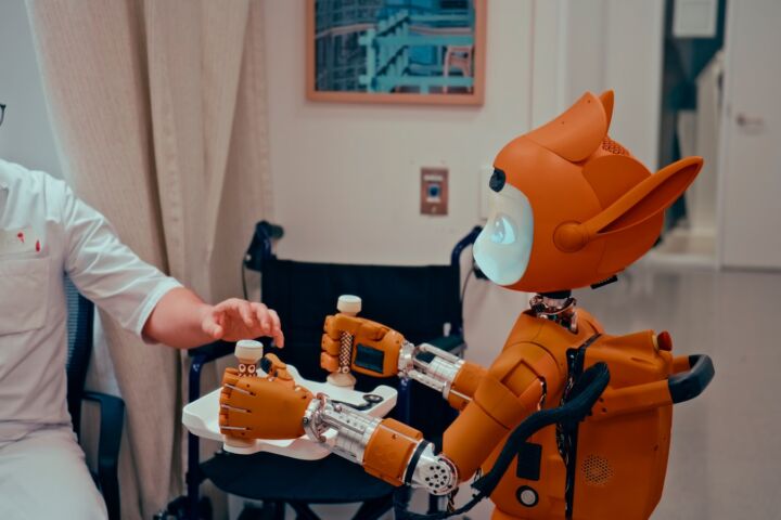Man gives robot bottles on a tray