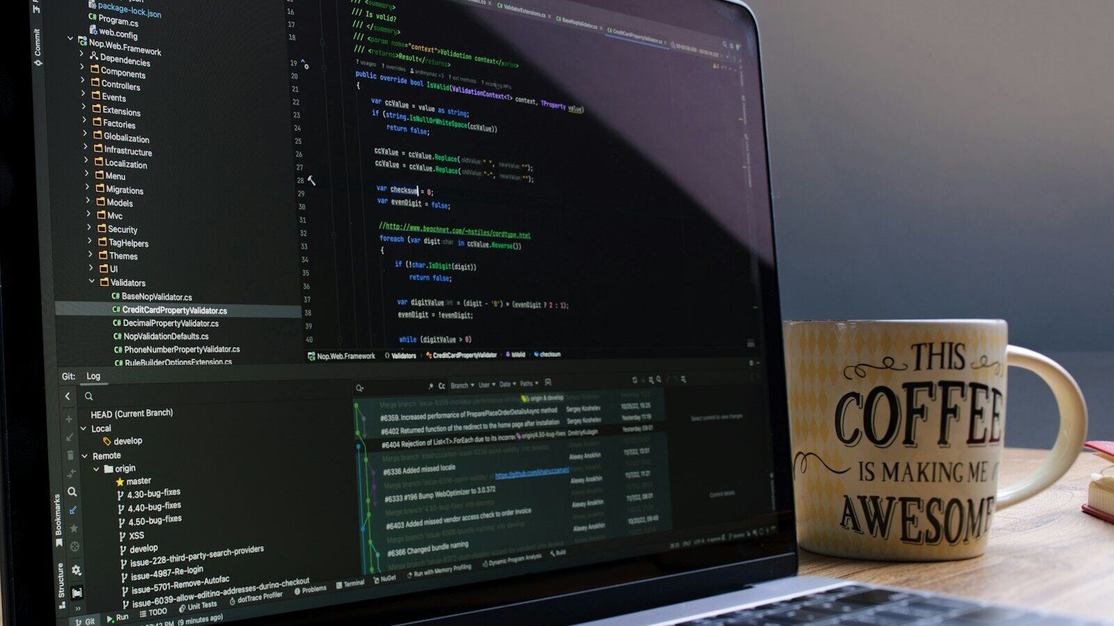 Laptop screen displaying code with a coffee mug.
