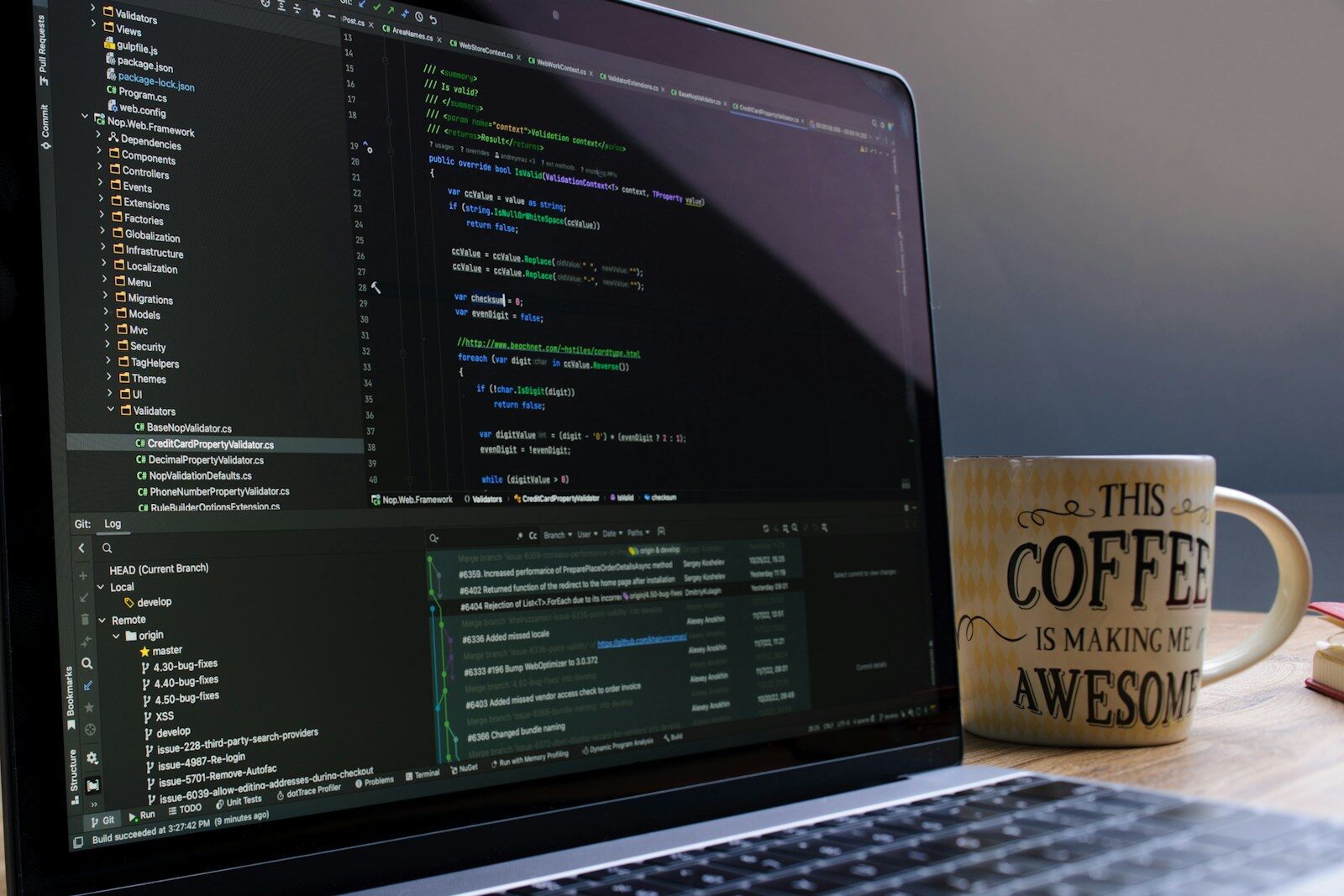 Laptop screen displaying code with a coffee mug.