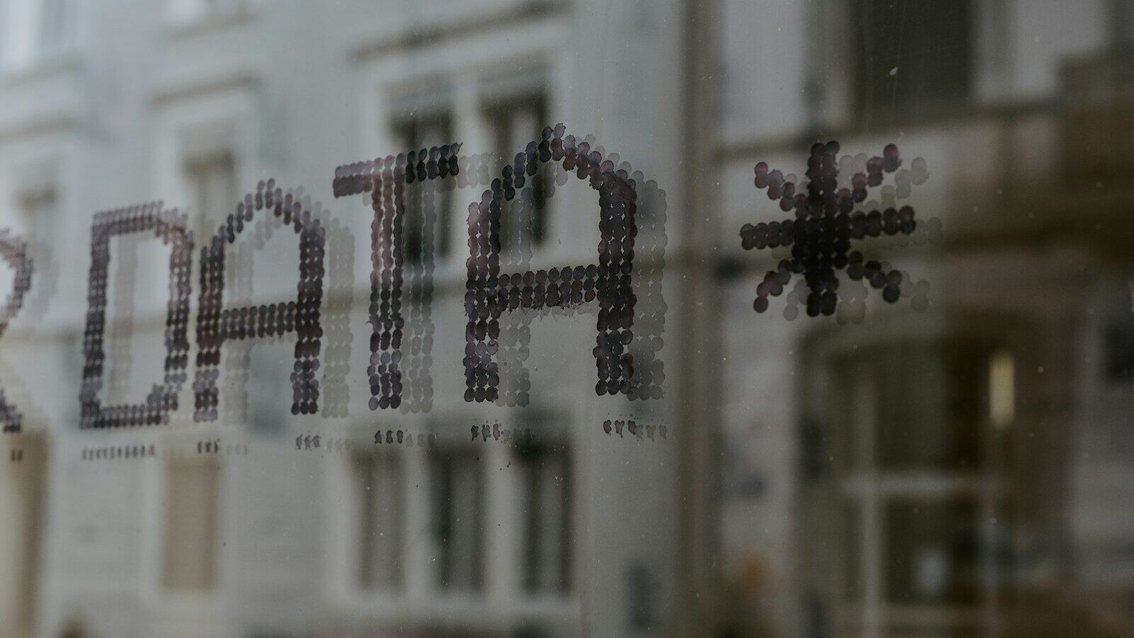 a close up of a window with a building in the background