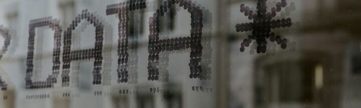a close up of a window with a building in the background