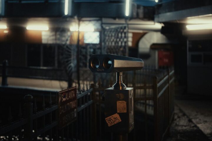 a pair of binoculars sitting on top of a metal fence