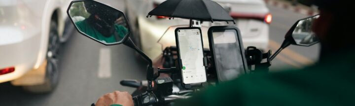 a man riding a motorcycle down a street next to traffic