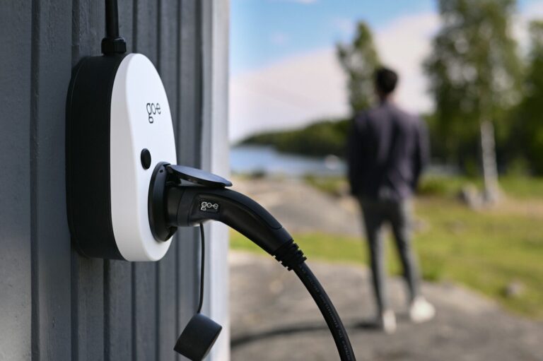 An electric vehicle charger is connected outdoors.