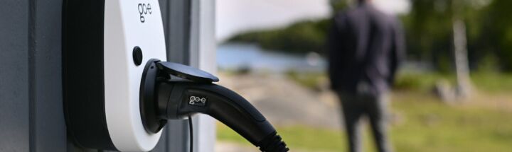 An electric vehicle charger is connected outdoors.