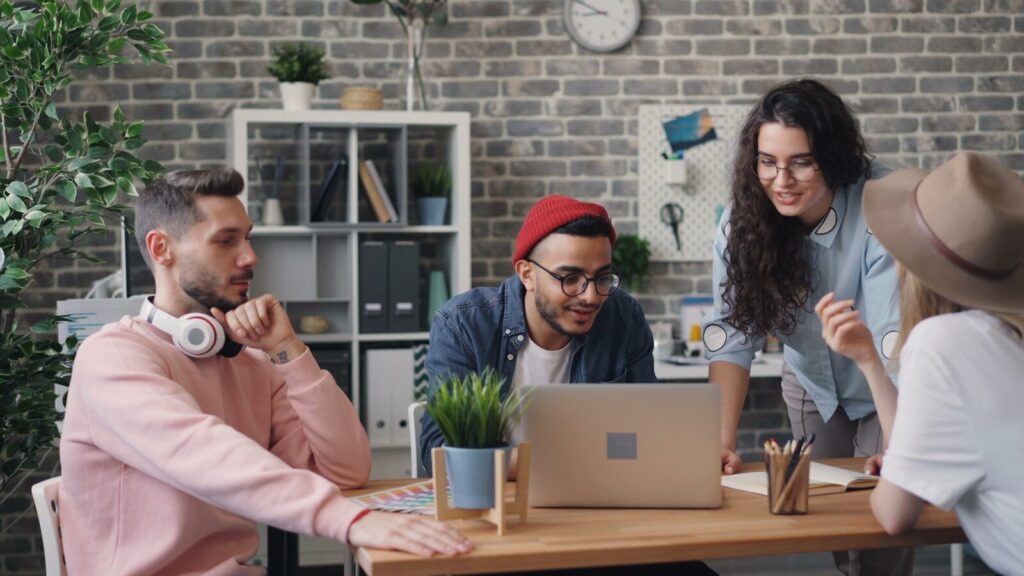 a group of people sitting around a wooden table