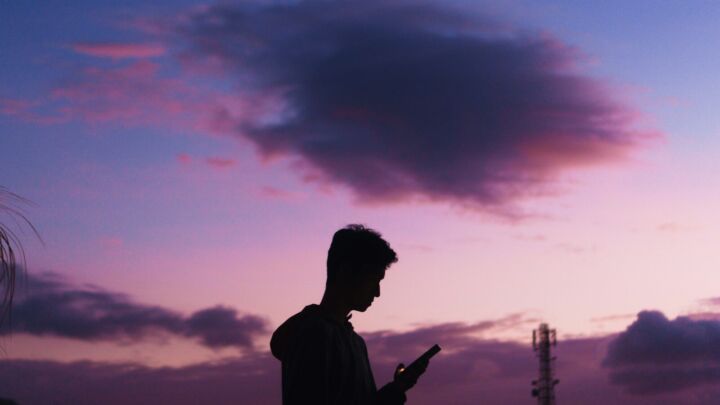 a man is looking at his cell phone