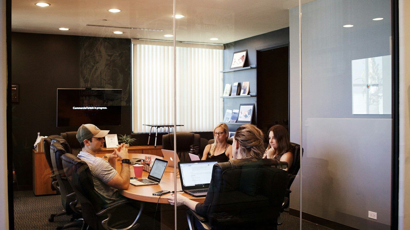 people sitting near table with laptop computer