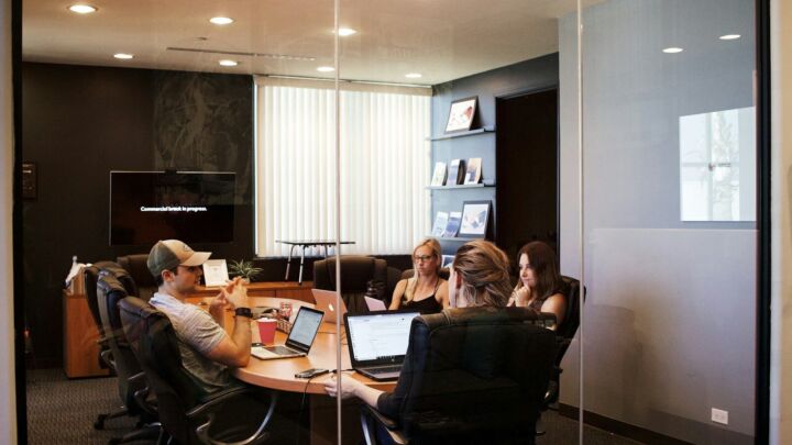 people sitting near table with laptop computer