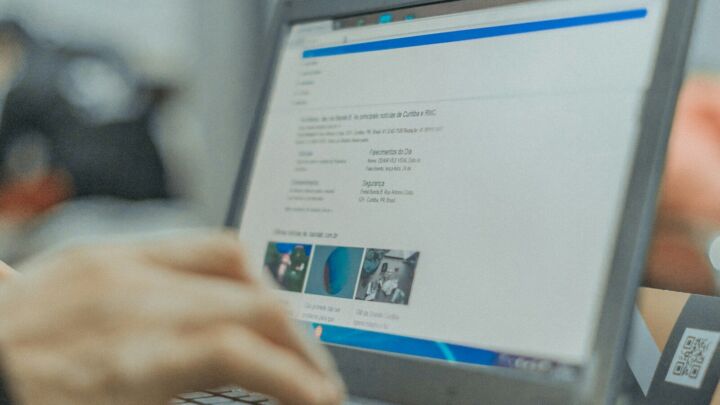 person in front of turned-on laptop computer